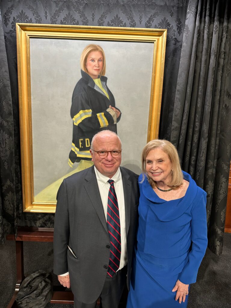 

Benjamin Chevat and former Congresswoman Carolyn Maloney, author of the James Zadroga 9/11 Health and Compensation Act of 2010, that created the World Trade Center Health Program and reopened the September 11th Victim Compensation Fund (VCF) at the unveiling of the Congresswoman’s Official Portrait as Chair of the House Goverent Oversight Committee, wearing the FDNY Bunker Coat that she wore to promote the need for the legislation. 